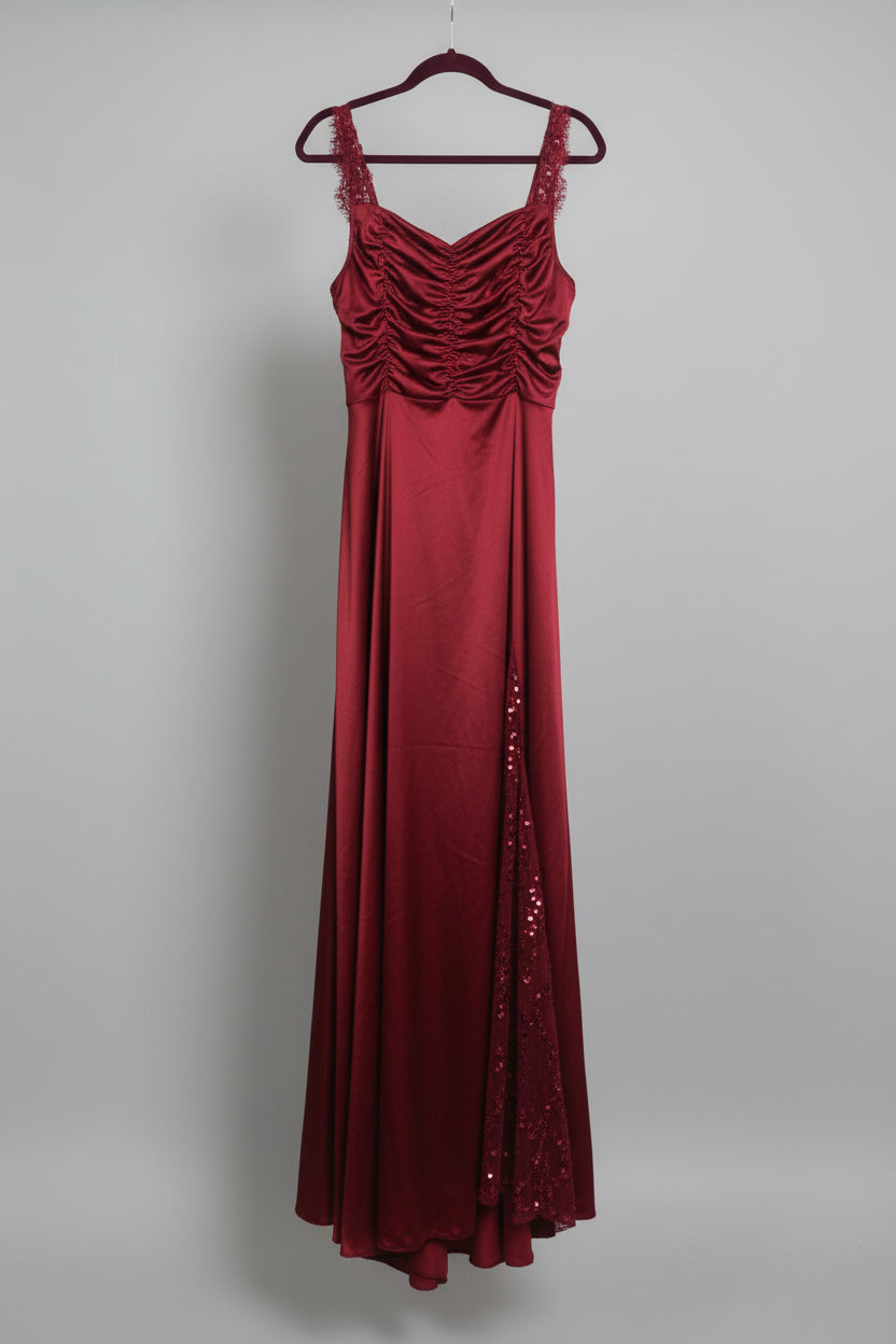 Burgundy long dress with sequin side slit displayed on hanger