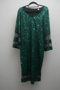 Full view of candy apple green glitter holiday dress with black sheer bell sleeves on hanger